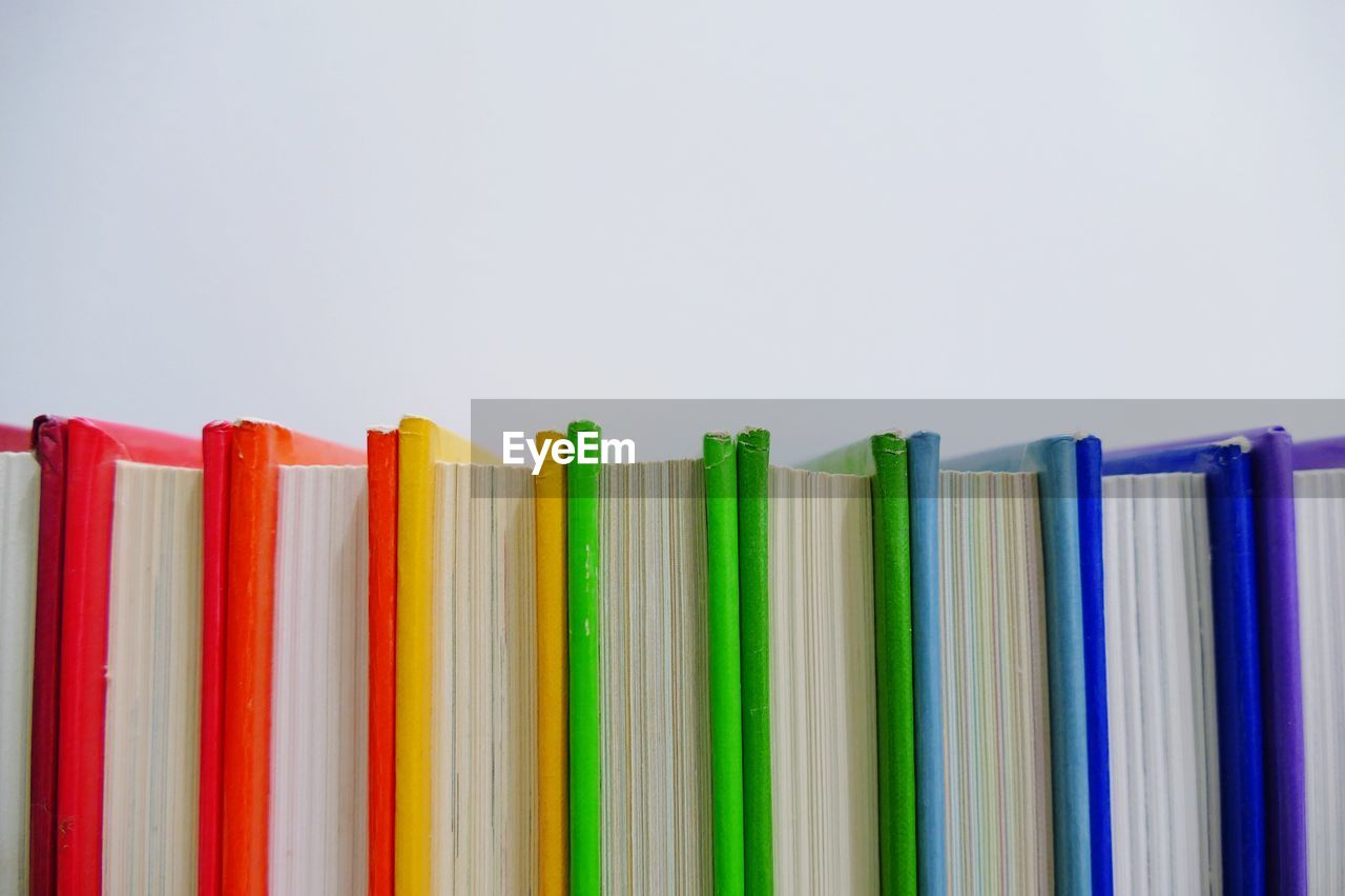 Close-up of colorful books against white background