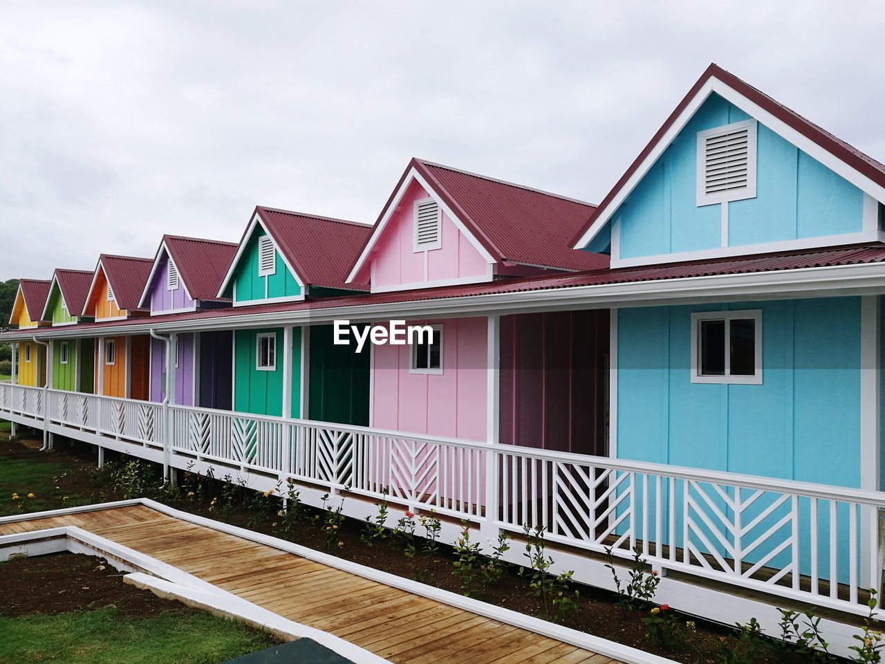 MULTI COLORED HOUSES ON BUILDING AGAINST SKY