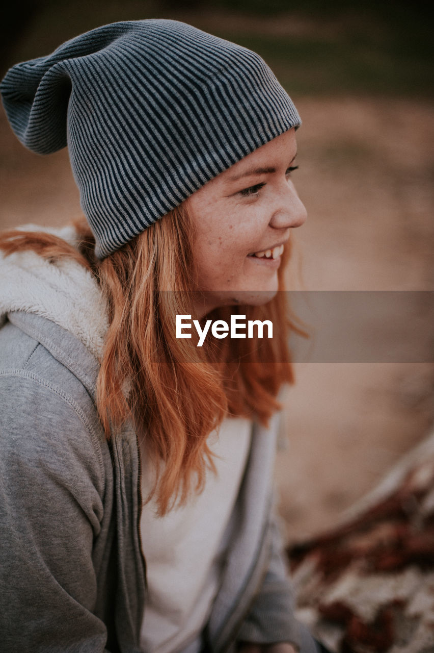Close-up of smiling woman looking away