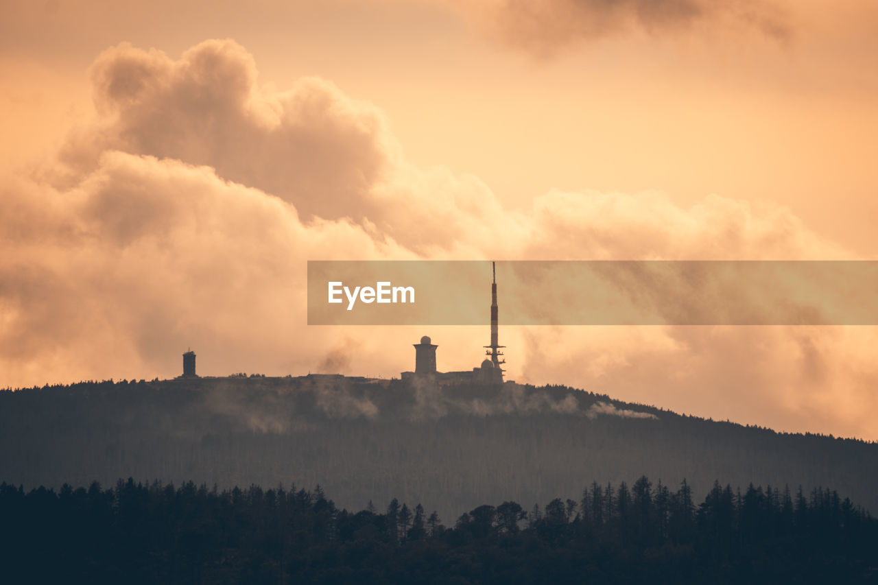 Silhouette of building against sky during sunset