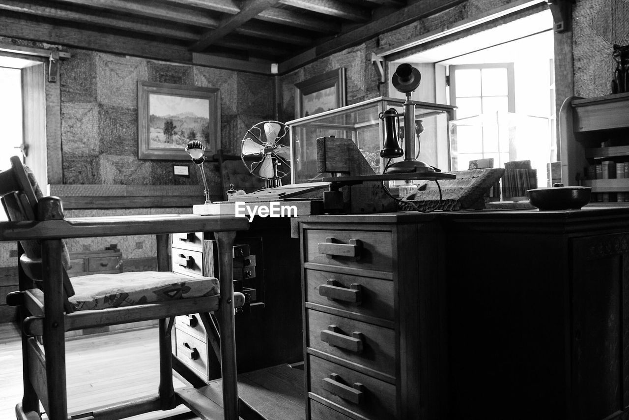 Empty chair by table in old-fashioned office