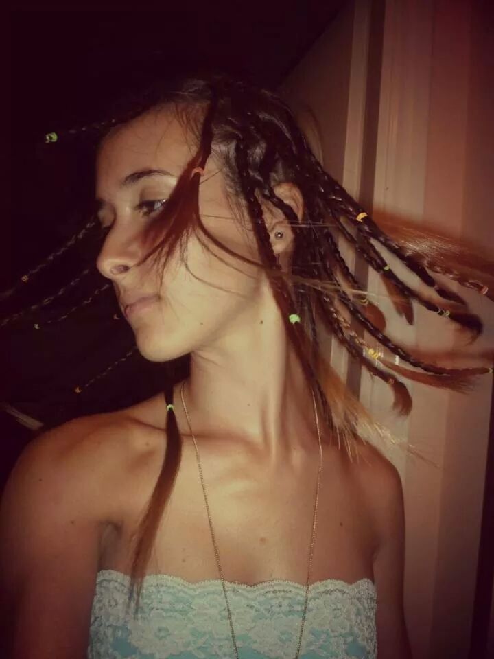 Teenage girl tossing braided hair