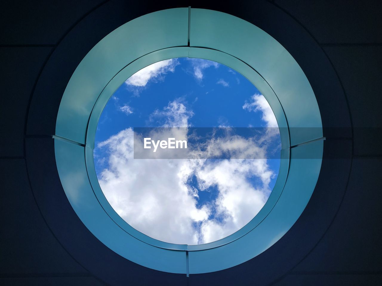 cloud, sky, blue, geometric shape, circle, shape, glass, nature, window, directly below, reflection, no people, light, architecture, low angle view, built structure, outdoors, day
