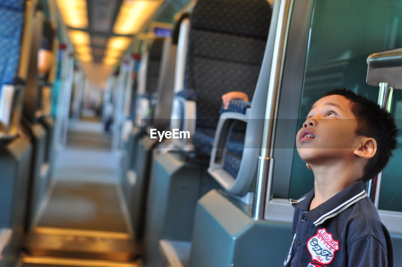 SIDE VIEW OF BOY IN TRAIN