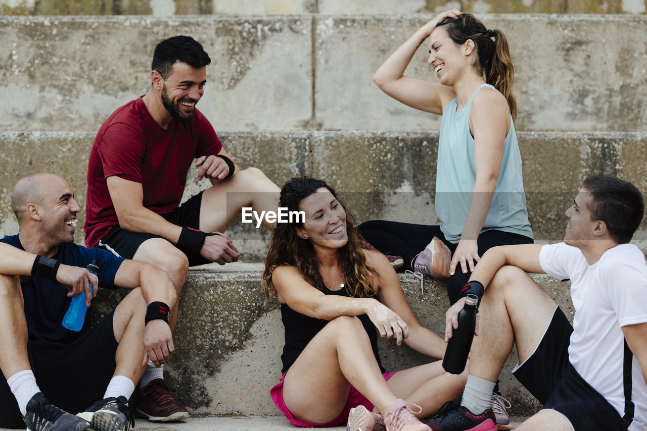 Group of athletes sitting relaxed after practicing crossfit.