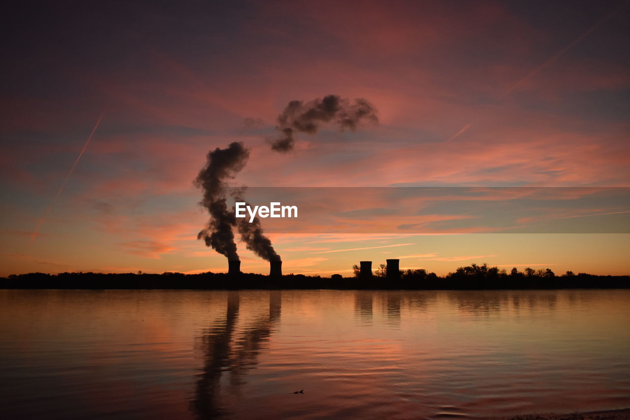 SMOKE EMITTING FROM CHIMNEY AGAINST SKY DURING SUNSET