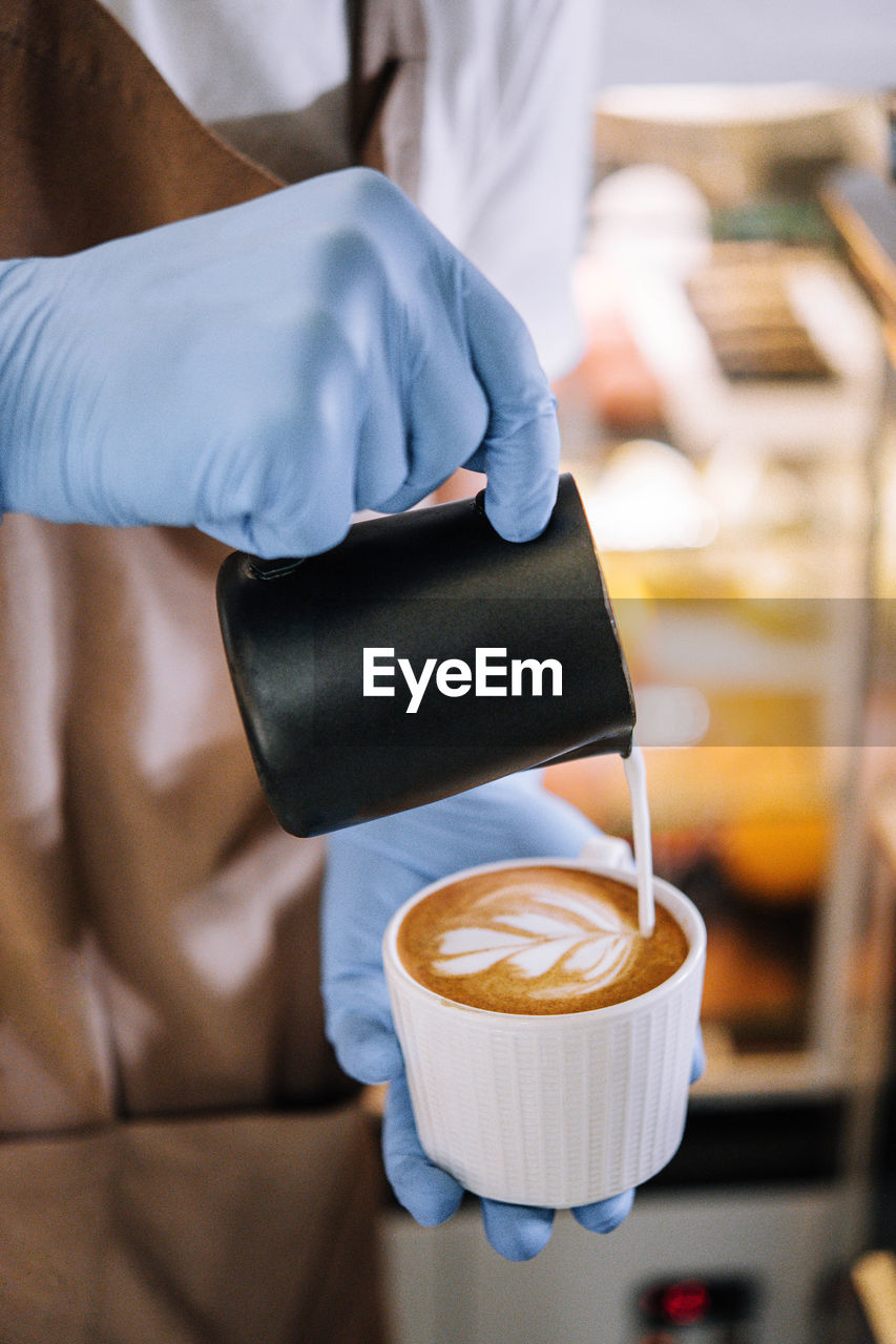 midsection of man holding coffee