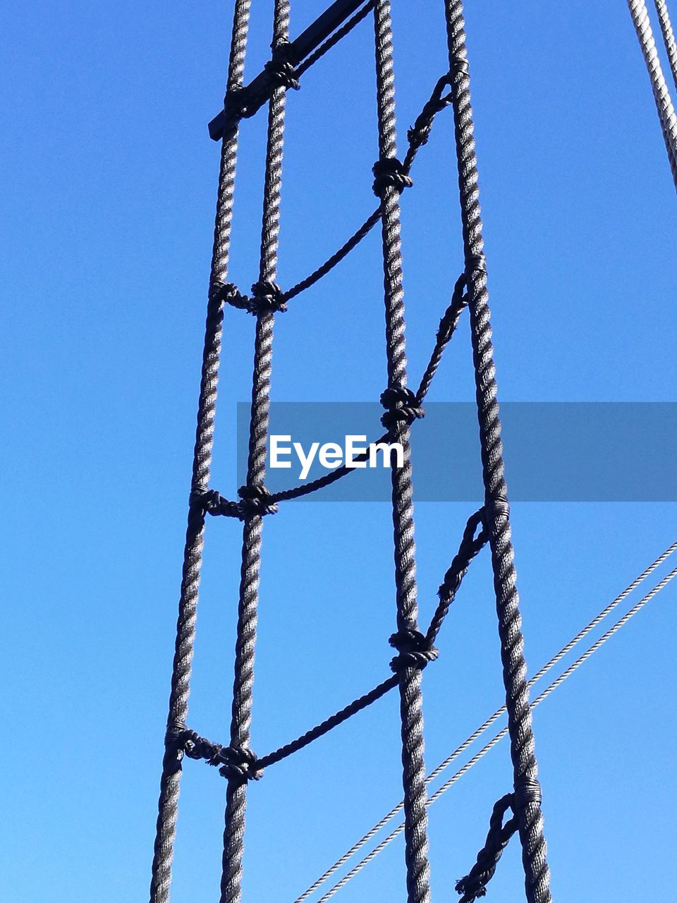 LOW ANGLE VIEW OF BRIDGE AGAINST CLEAR BLUE SKY