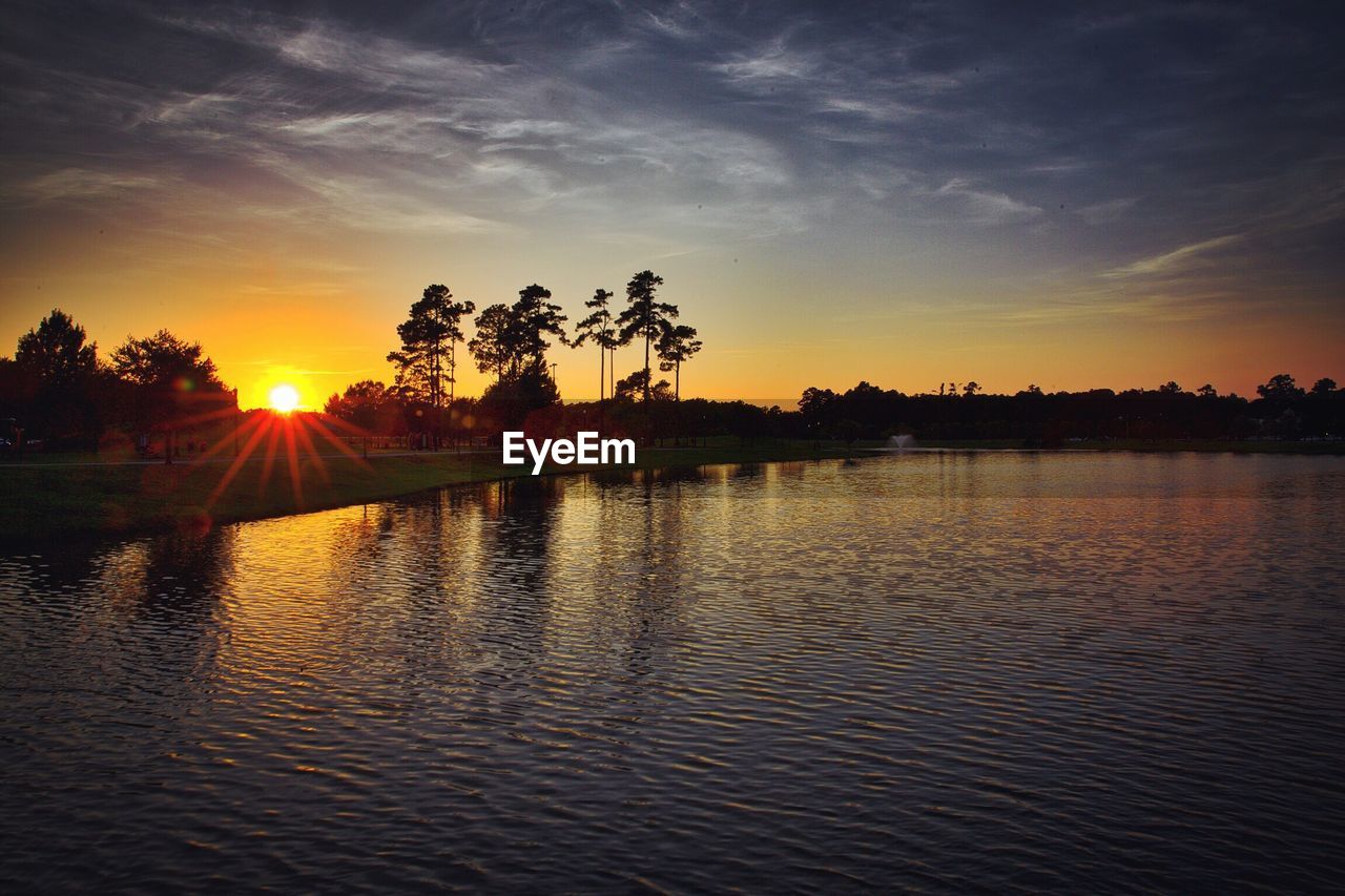 Scenic view of lake against sky during sunset