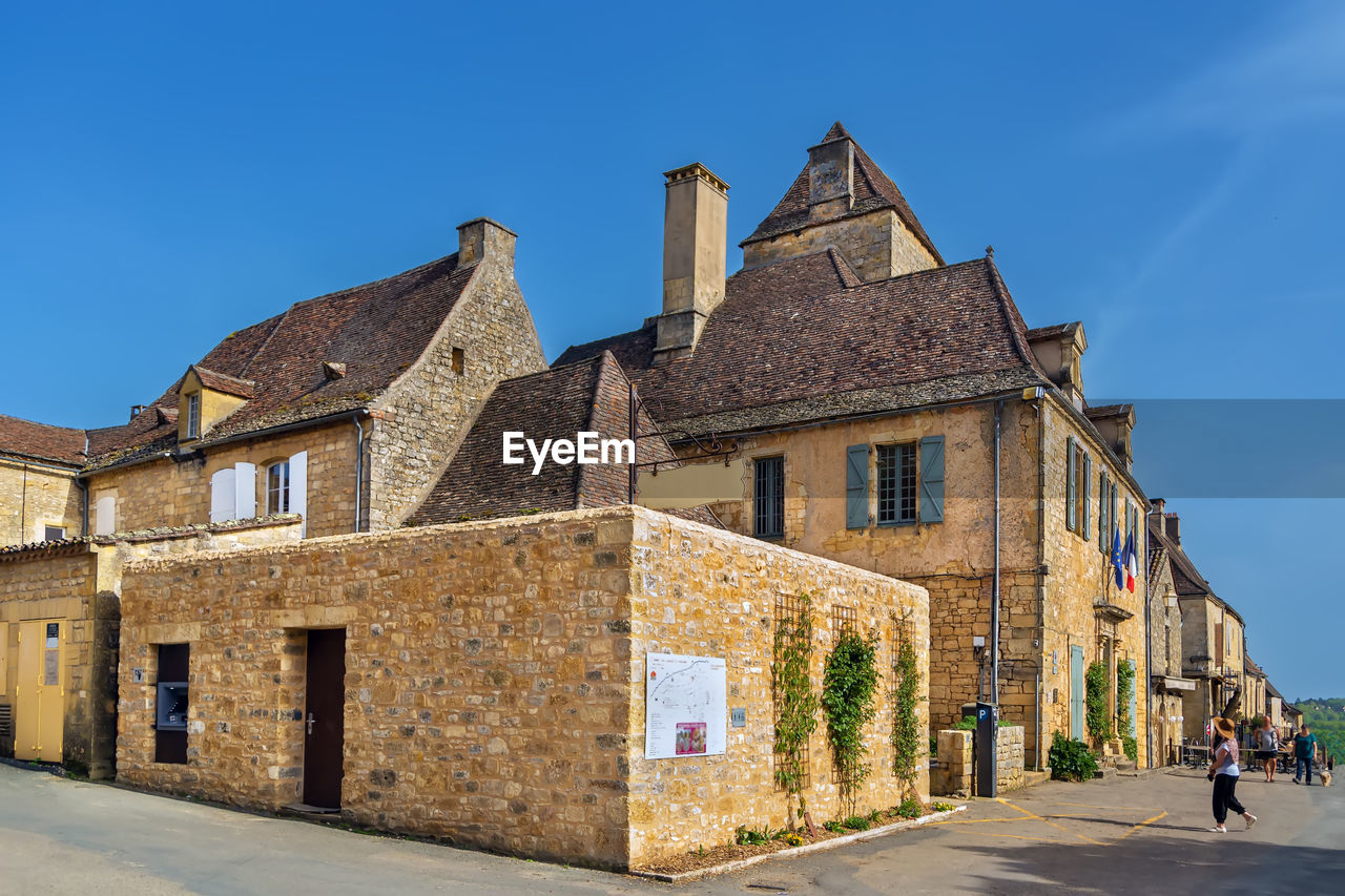 Street with historical houses in domme commune in the dordogne department, france