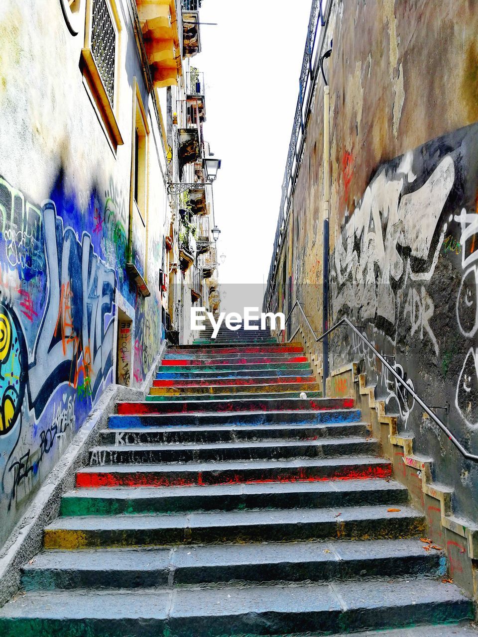 LOW ANGLE VIEW OF STEPS AMIDST BUILDINGS