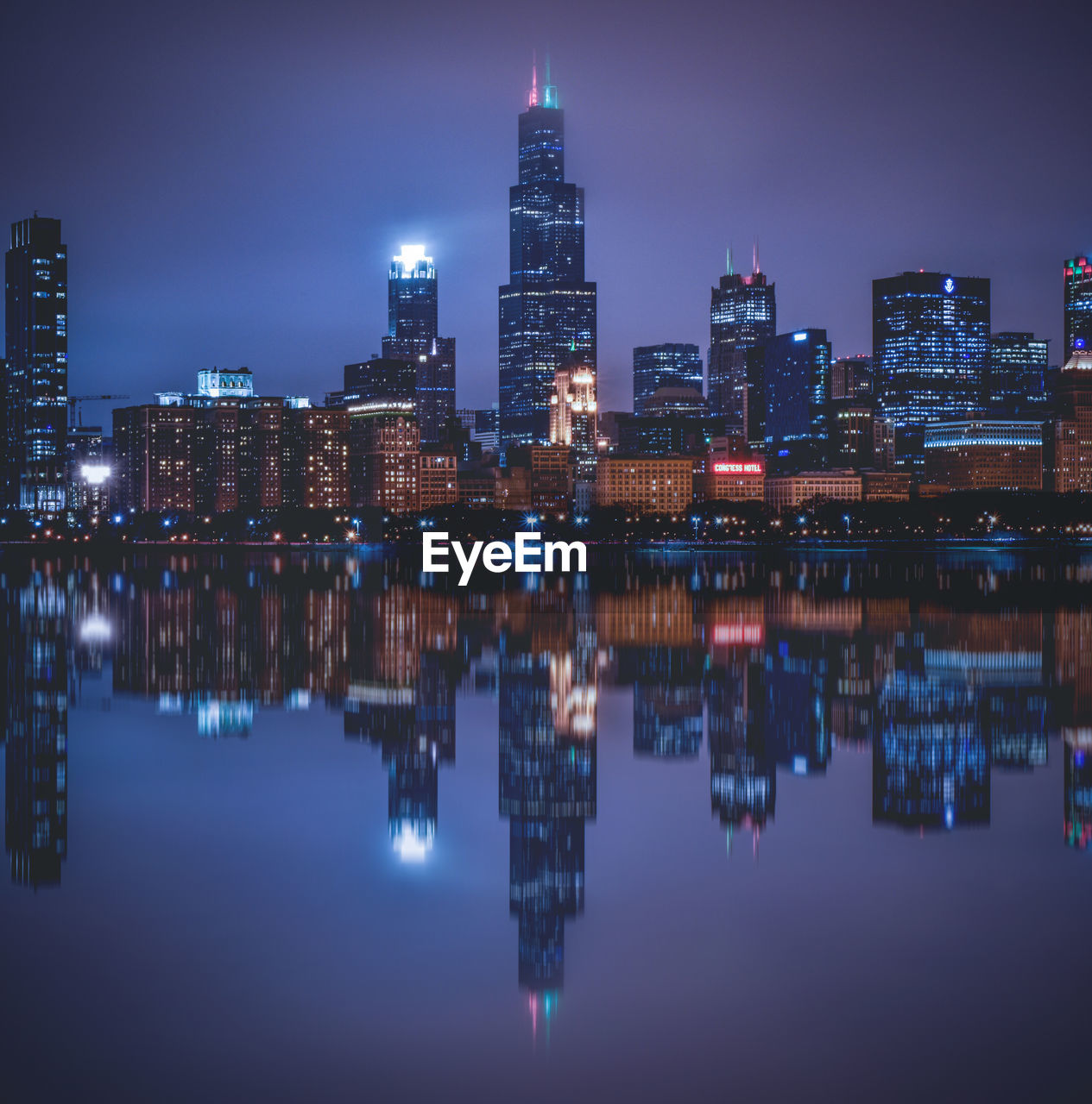 Reflection of illuminated buildings in city at night