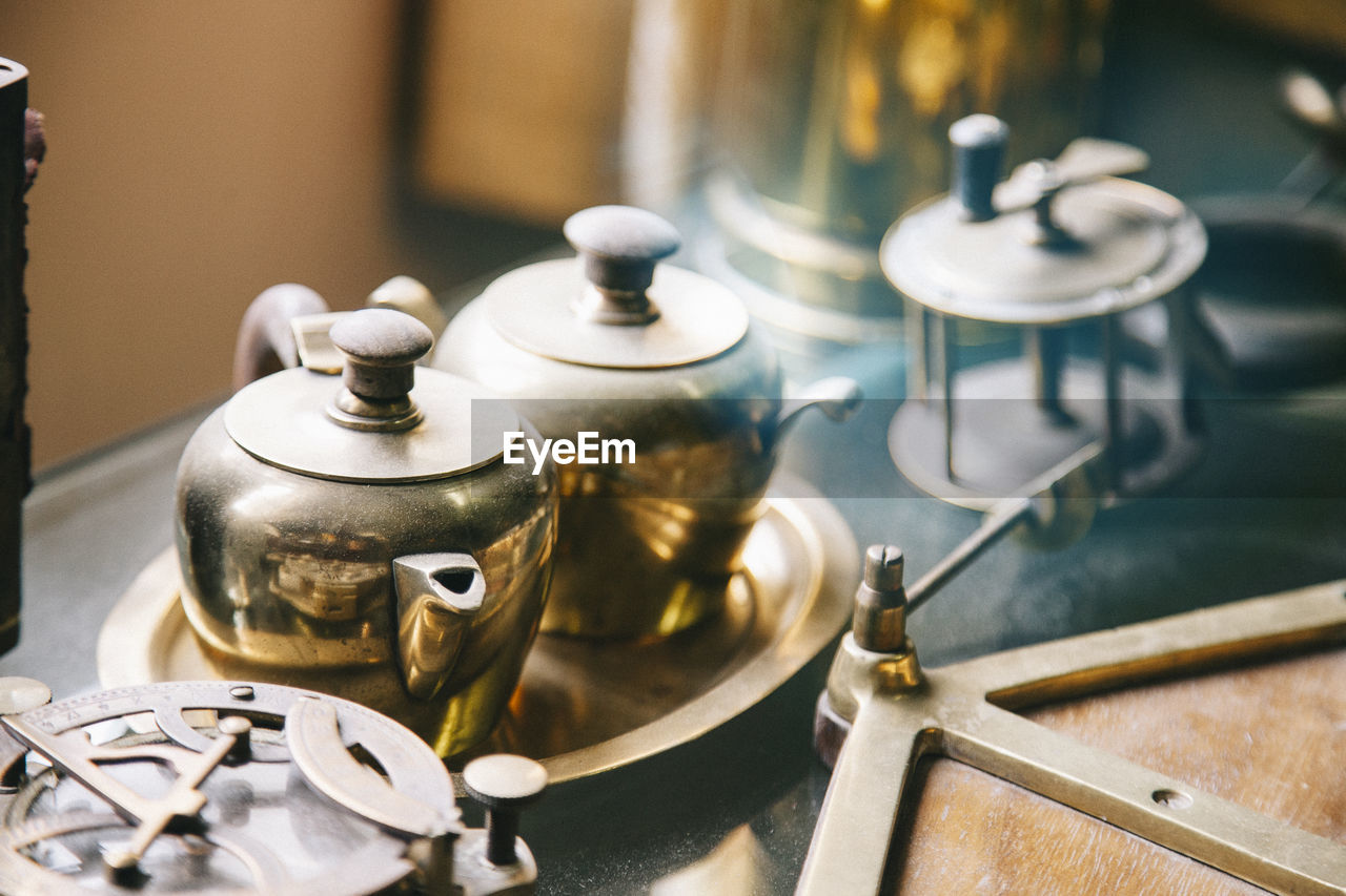 Close-up of tea kettles in kitchen