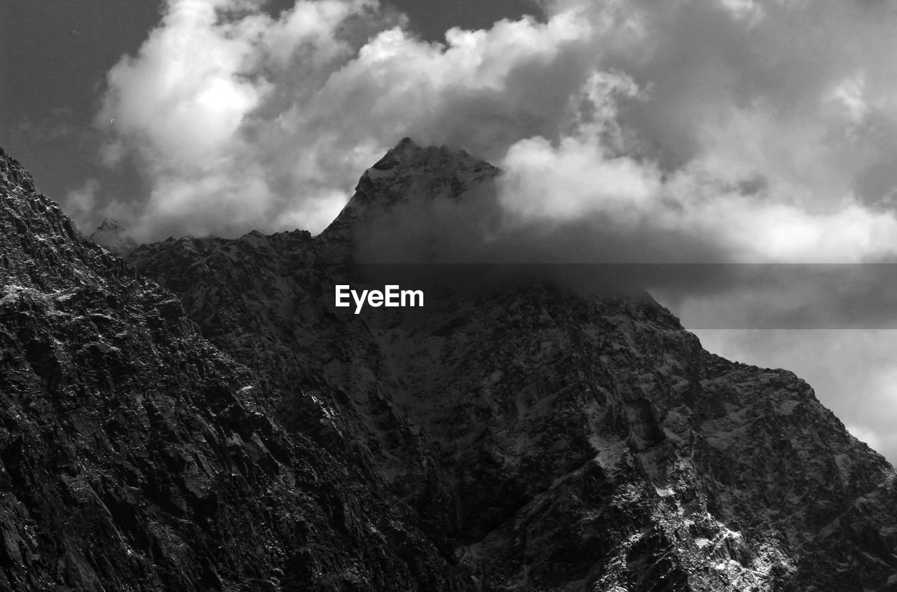 LOW ANGLE VIEW OF ROCKY MOUNTAIN AGAINST SKY