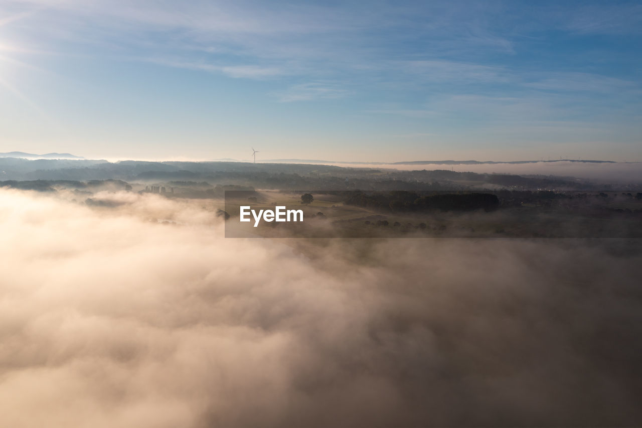 cloud, sky, environment, scenics - nature, beauty in nature, nature, horizon, landscape, mountain, fog, no people, cloudscape, sunlight, tranquility, morning, outdoors, travel, aerial view, mist, dawn, tranquil scene, idyllic, copy space, day, blue, high up, awe, high angle view