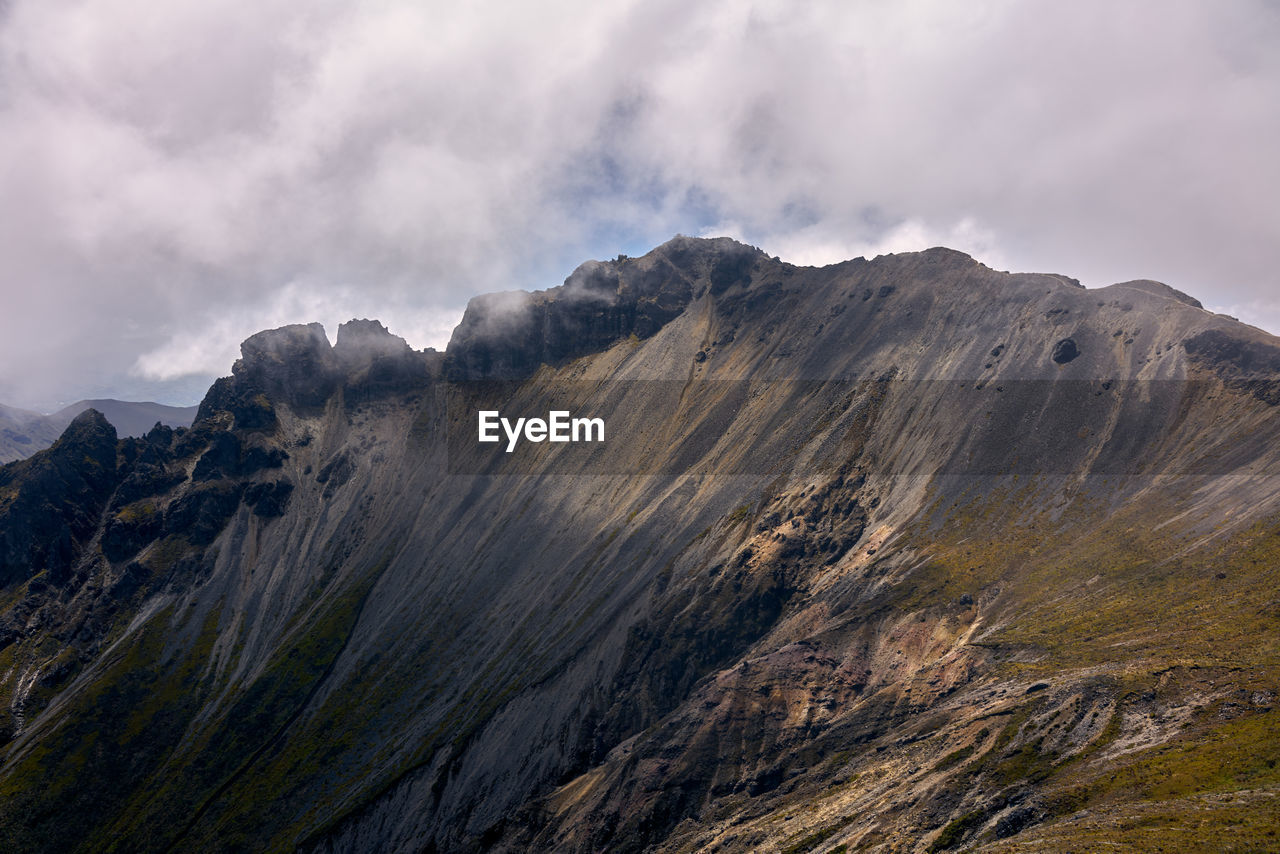 Scenic view of volcanic mountain range against sky
