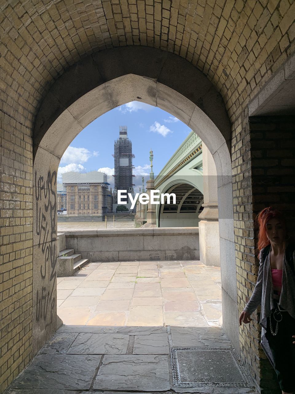 VIEW OF HISTORIC BUILDING SEEN THROUGH ARCHWAY