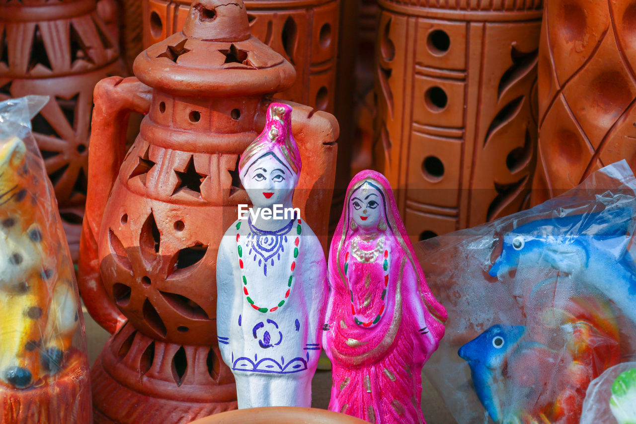 Close-up of bride and groom dolls for sale in market
