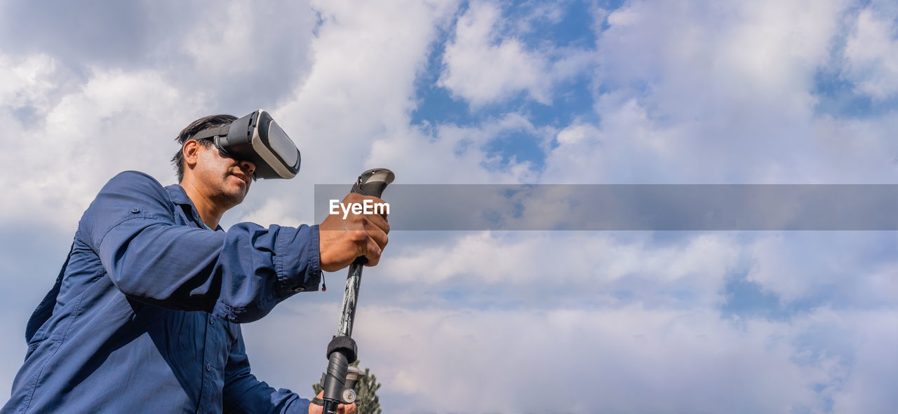 Low angle view of man standing against sky