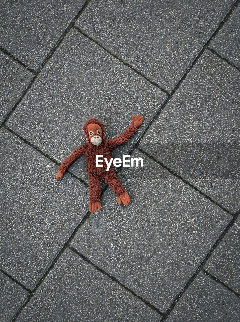 HIGH ANGLE VIEW OF RED TOY ON FLOORING