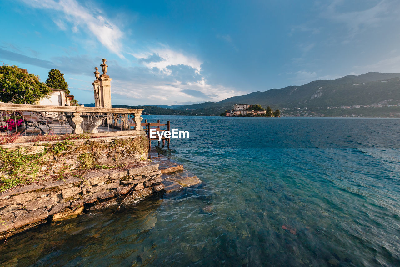 View of a building on lake orta with the island of san giulio in the background