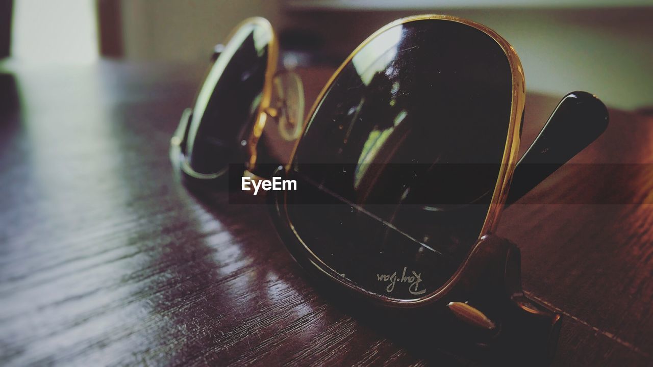 CLOSE-UP OF GLASSES ON TABLE AT HOME