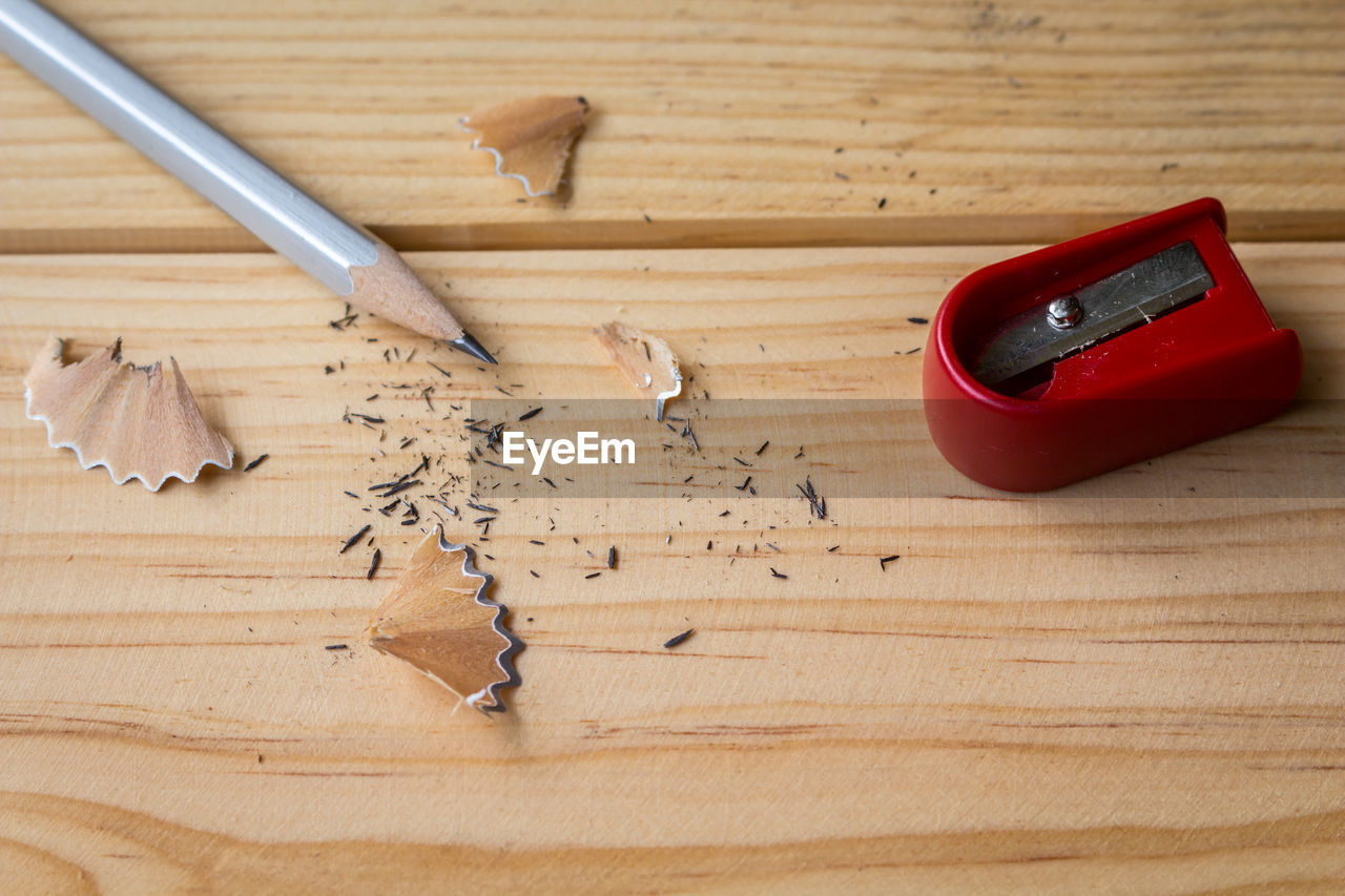 Pencil with shavings and sharpener on table