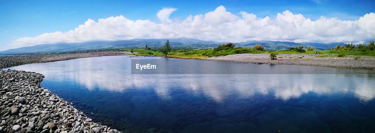 Panoramic view of lake against blue sky