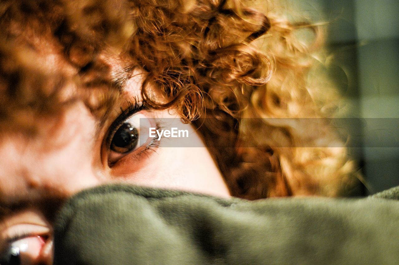 Close-up portrait of young woman with curly hair