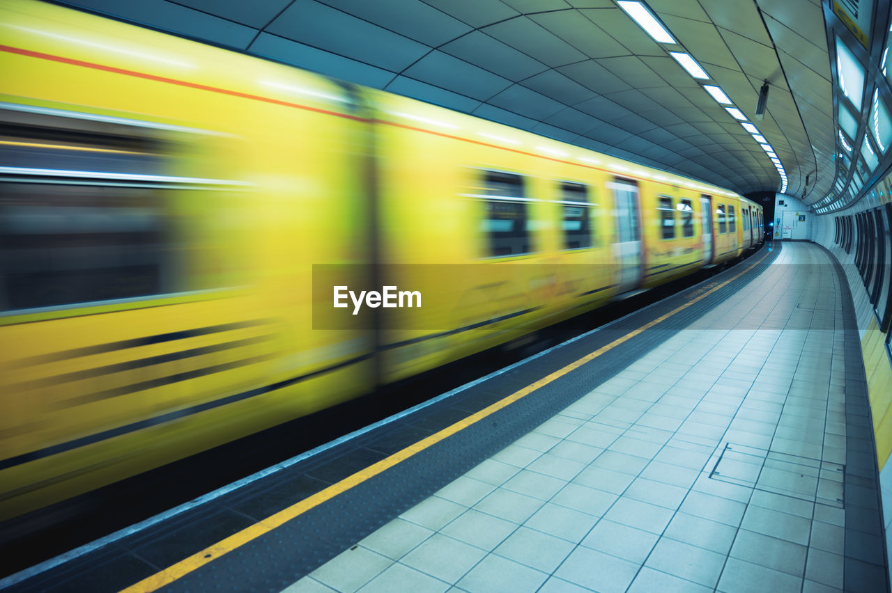 Blurred motion of train at railroad station