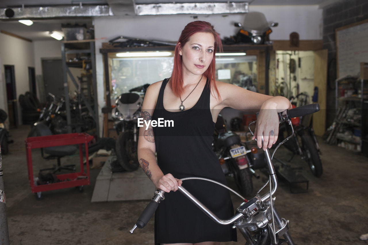 A young woman with a motorcycle.