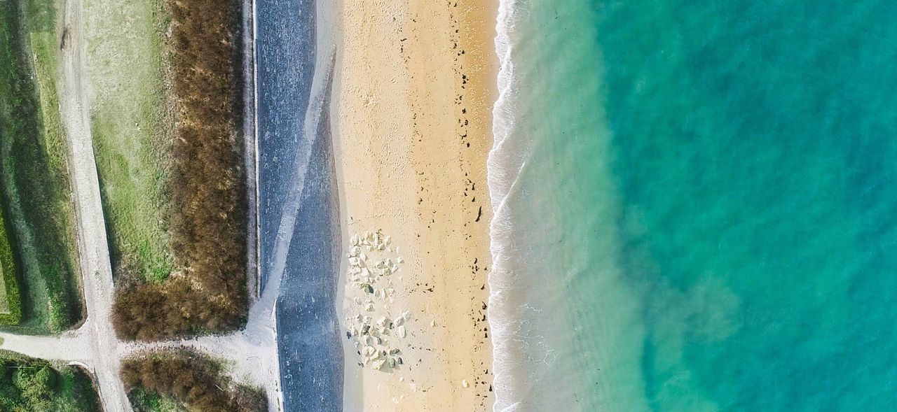 CLOSE-UP OF MULTI COLORED SAND ON BEACH