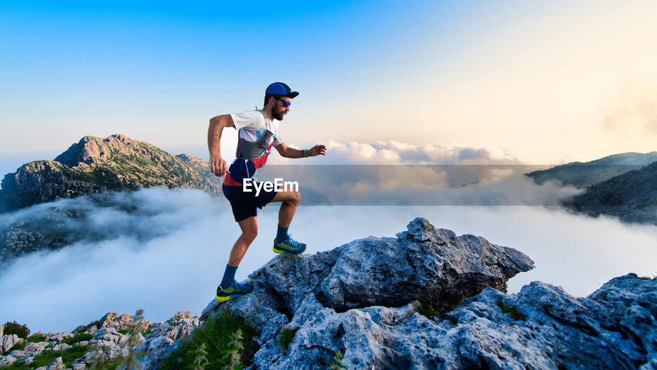 Man ultramarathon runner in the mountains during a workout