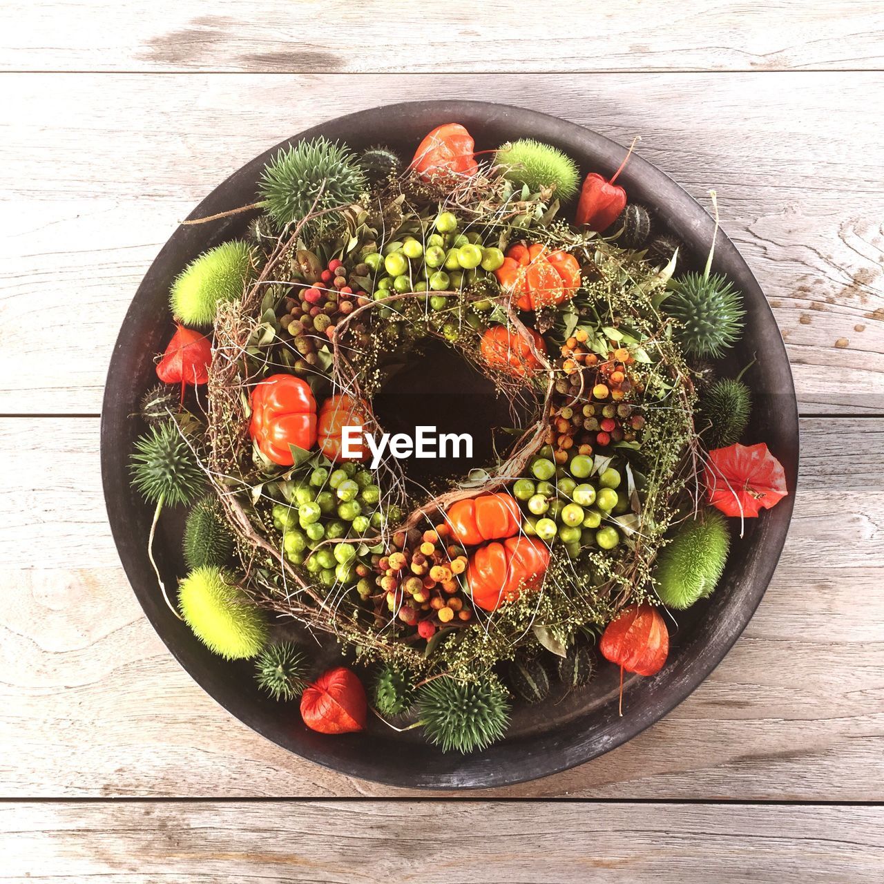 High angle view of christmas wreath made from fruits and vegetables on table