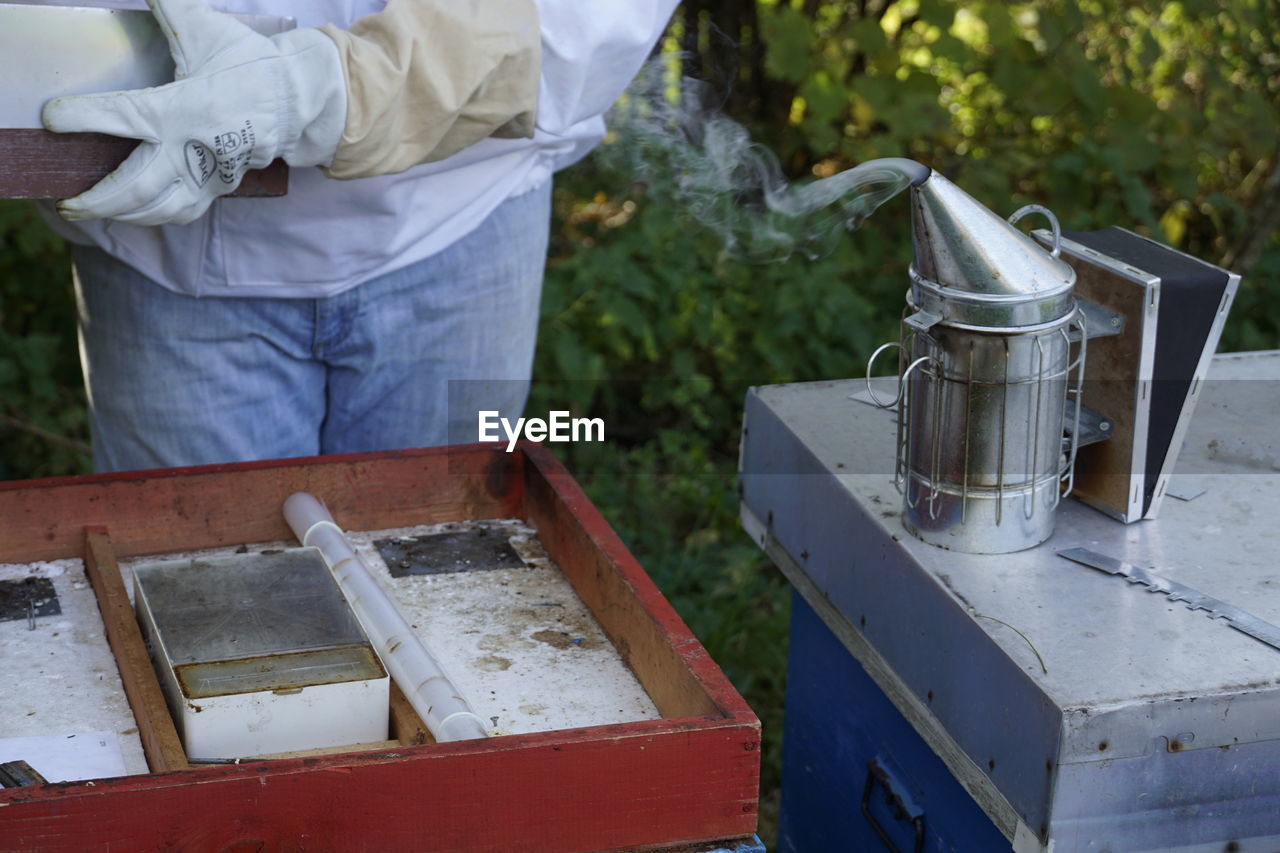 beekeeper, insect, one person, apiary, food, food and drink, occupation, container, bee, agriculture, protective workwear, adult, nature, animal, working, men, protective glove, plant, rural scene, apiculture, beehive, protection, day, honey, outdoors, freshness, farm, business, box, standing, holding