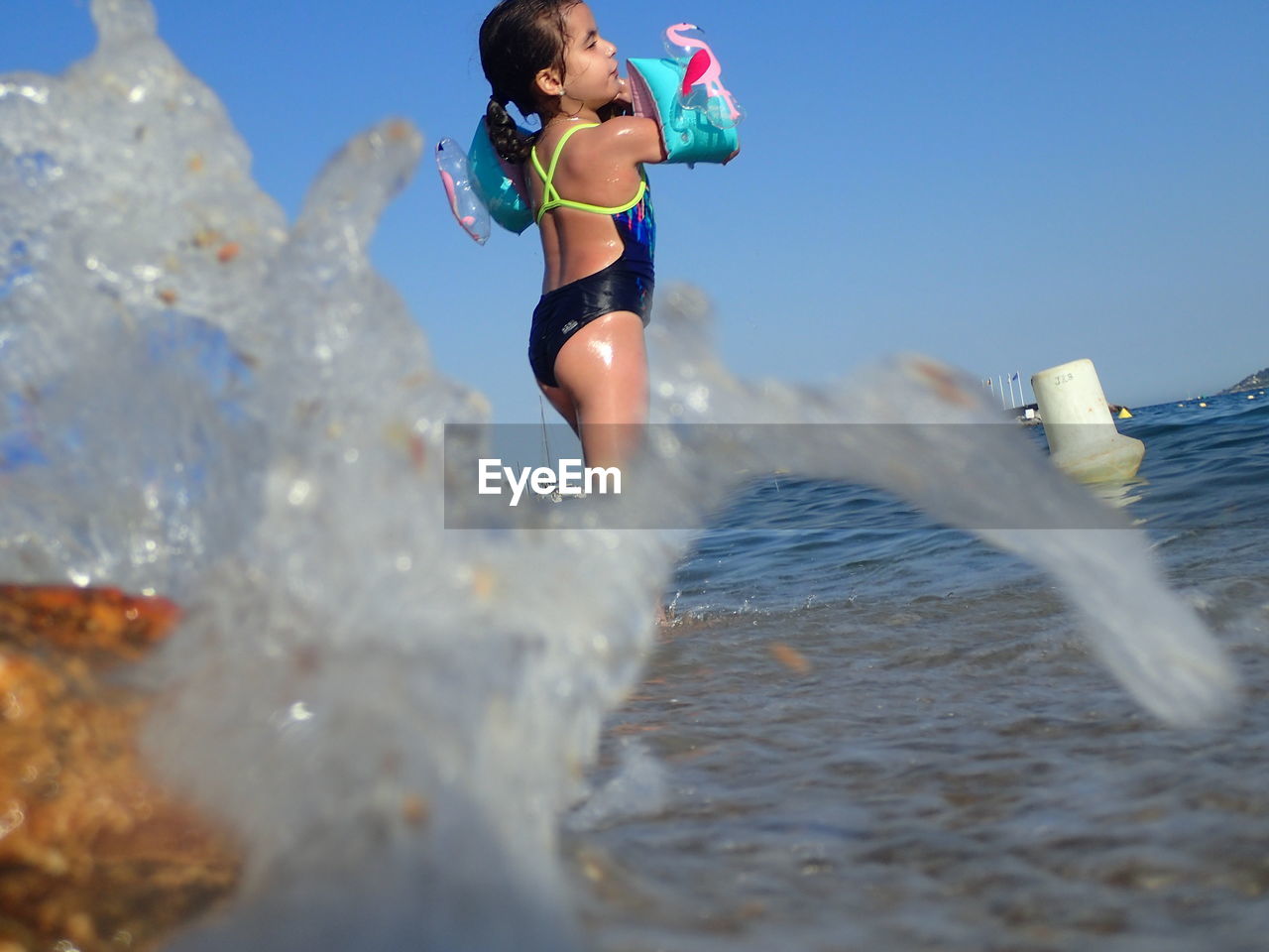 WOMAN IN SEA AGAINST SKY