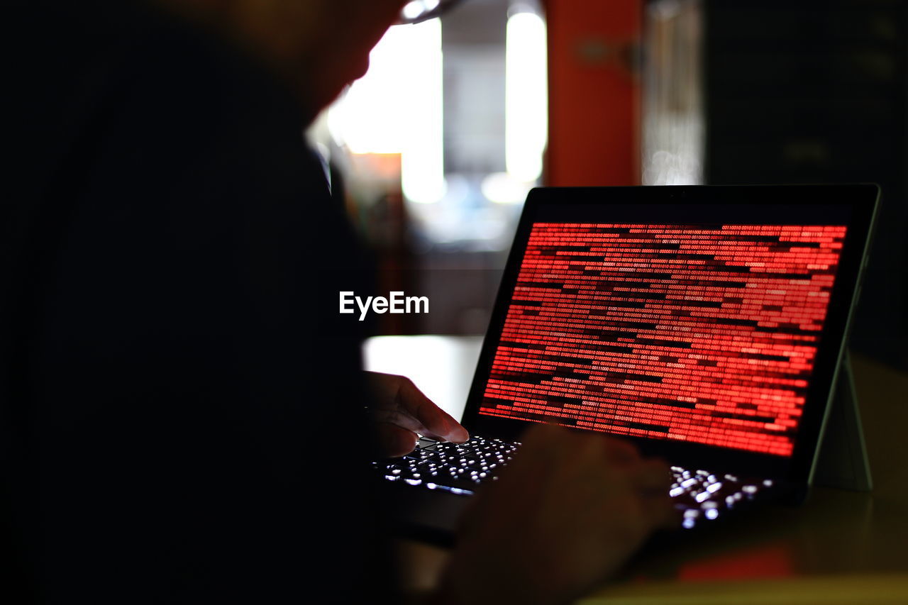 Midsection of man using laptop