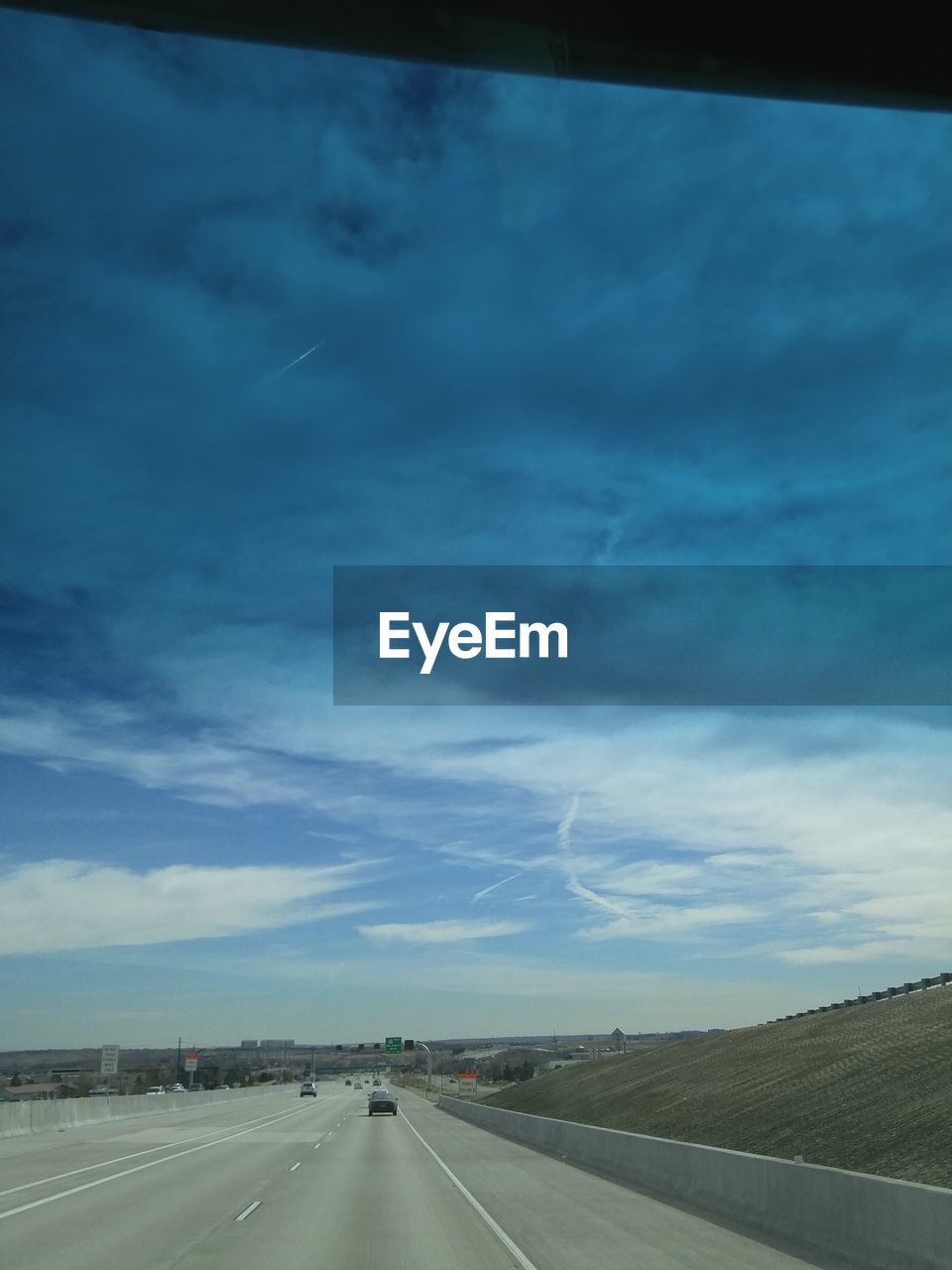 VIEW OF ROAD AGAINST CLOUDY SKY