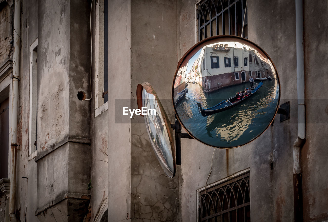 Reflection of building and boat on mirror in venecia