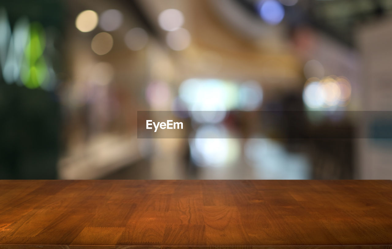 table, wood, focus on foreground, illuminated, no people, night, indoors, architecture, business, light, lighting equipment, seat