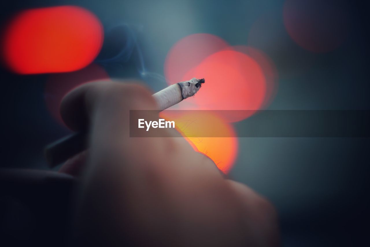 Close-up of a hand holding cigarette