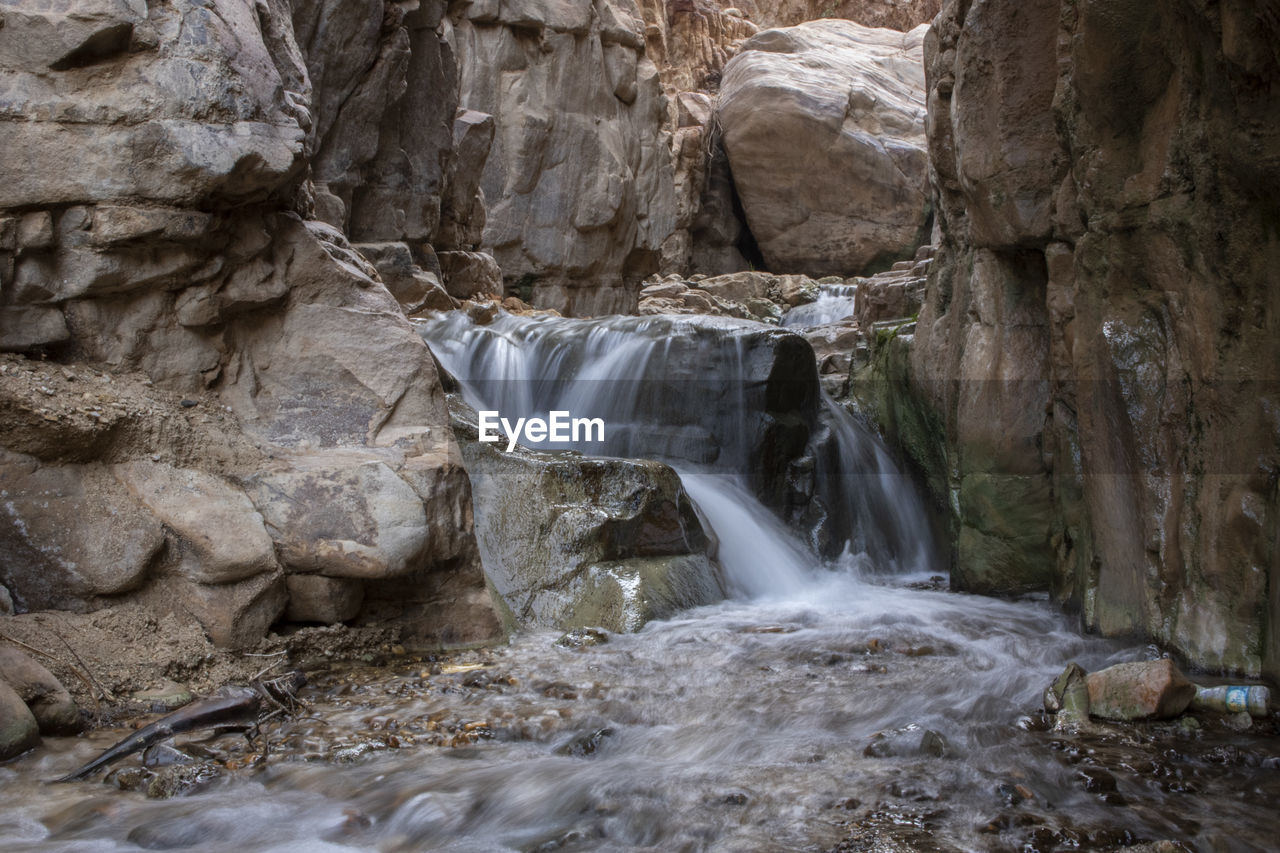 The waterfall and running river across the sandstone rocks