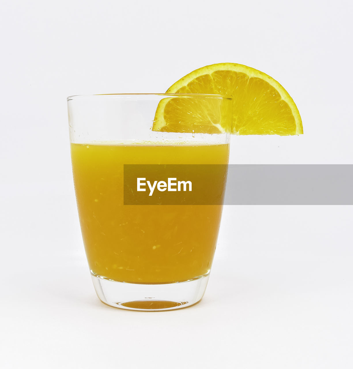 Close-up of orange slice on drink against white background