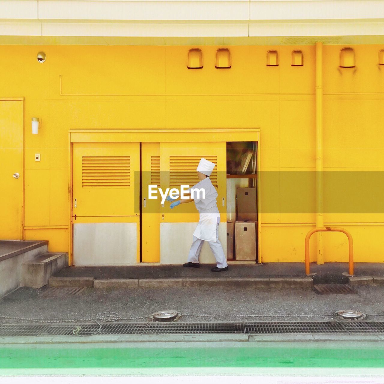 Man standing in yellow building