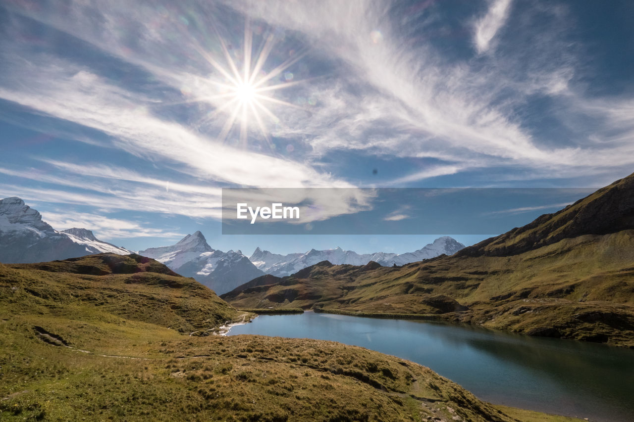 View of calm lake with mountain range in background