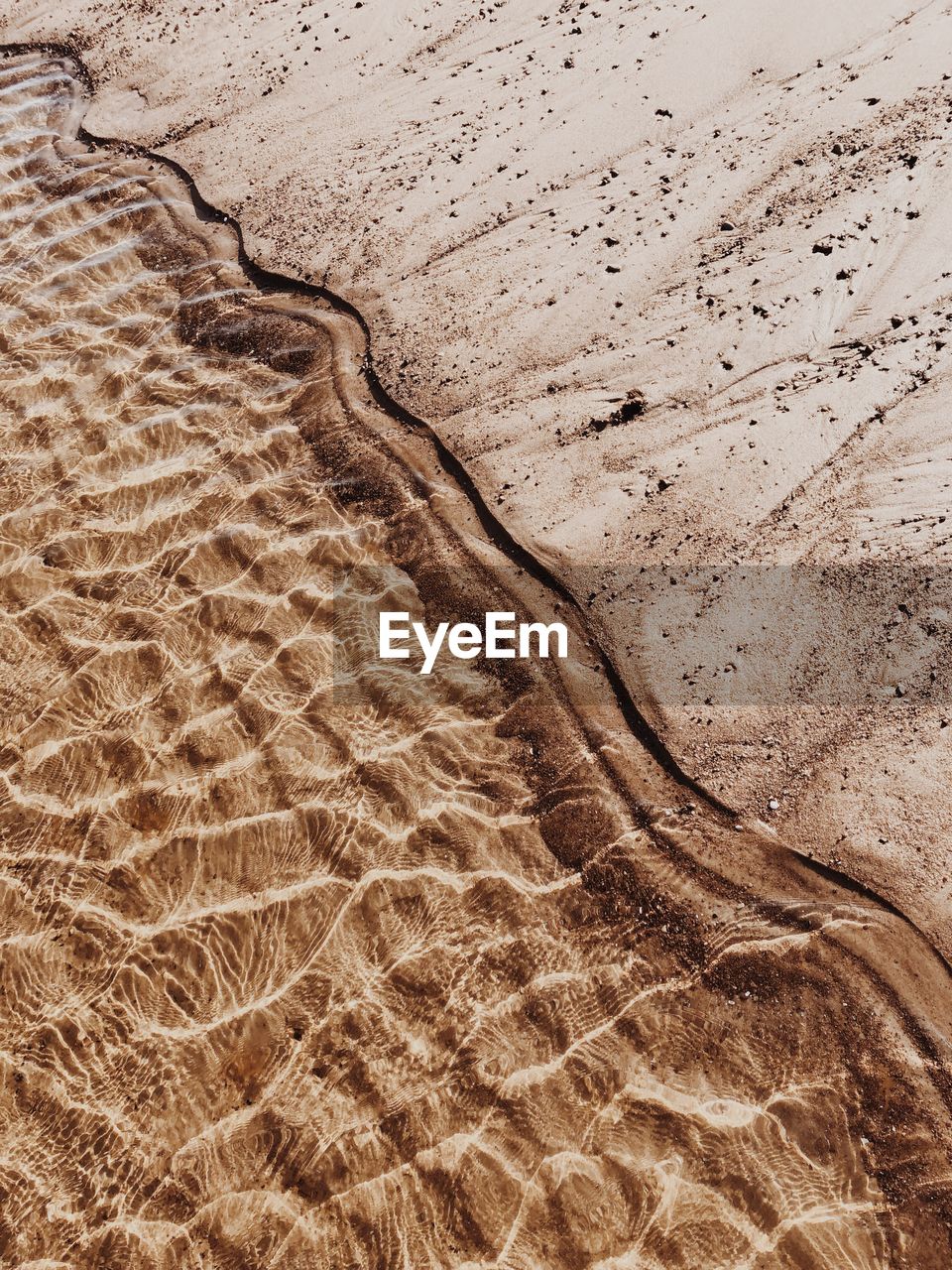 HIGH ANGLE VIEW OF SAND DUNES ON BEACH