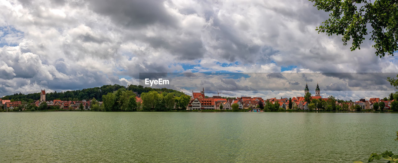 cloud, water, sky, architecture, nature, city, reflection, built structure, tree, building, building exterior, plant, landscape, environment, panoramic, river, travel destinations, no people, beauty in nature, cityscape, scenics - nature, outdoors, morning, horizon, body of water, travel, land, tourism, day, waterfront, mountain, tranquility, house