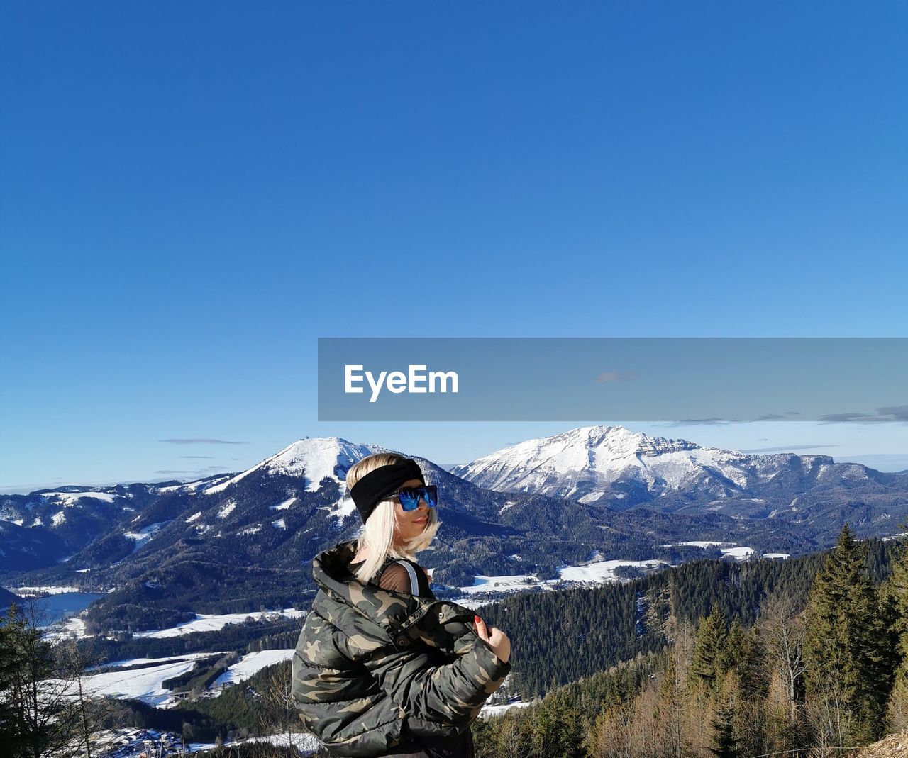 FULL LENGTH OF PERSON ON SNOWCAPPED MOUNTAINS AGAINST CLEAR BLUE SKY