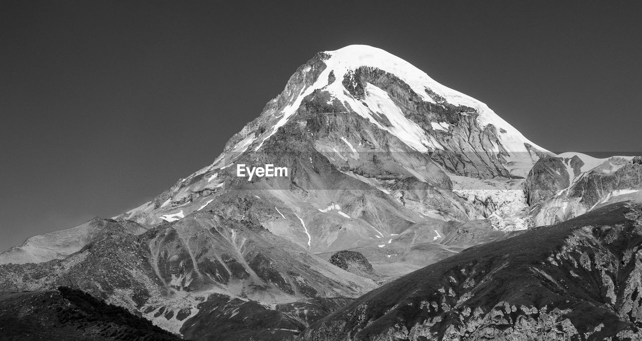 SNOWCAPPED MOUNTAINS AGAINST CLEAR SKY