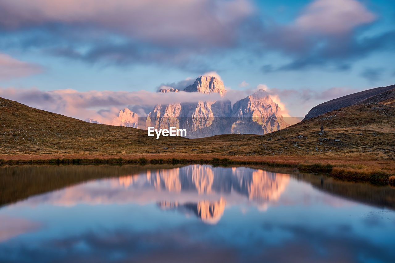 Scenic view of lake and mountains against sky